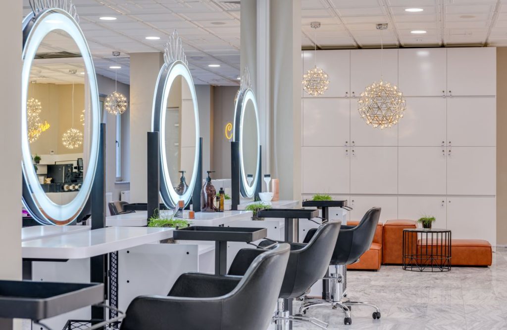 Bright salon interior with arched mirrors and styling chairs.